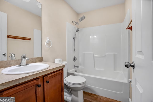 full bathroom featuring hardwood / wood-style flooring, vanity, toilet, and bathing tub / shower combination