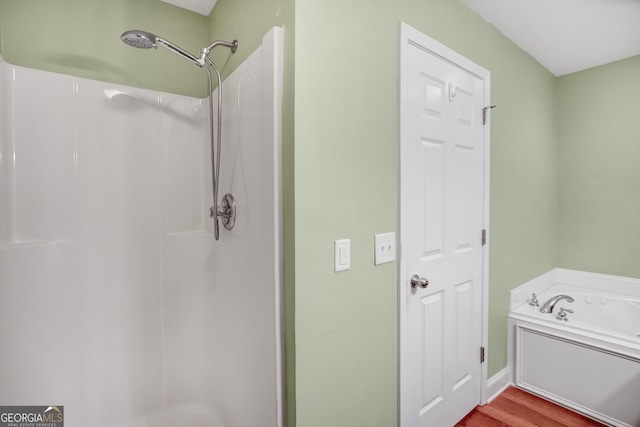 bathroom with wood-type flooring and independent shower and bath