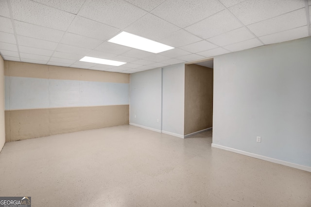 basement featuring a paneled ceiling