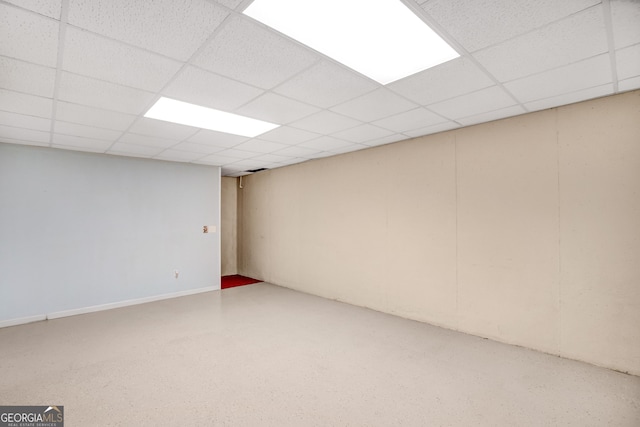 basement with a paneled ceiling