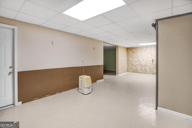 basement featuring a paneled ceiling