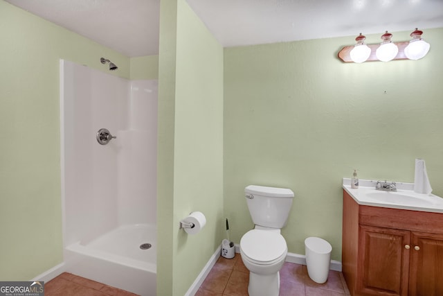 bathroom featuring tile patterned floors, a shower, vanity, and toilet