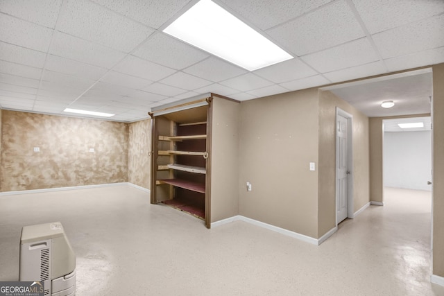 basement featuring a paneled ceiling