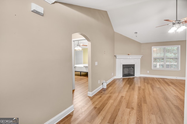 unfurnished living room featuring light hardwood / wood-style flooring, ceiling fan, and lofted ceiling