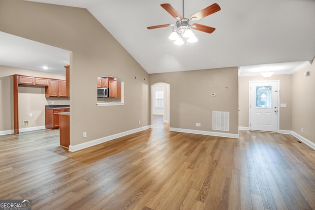 unfurnished living room with ceiling fan, light hardwood / wood-style floors, and high vaulted ceiling