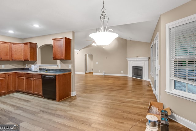 kitchen with black dishwasher, decorative light fixtures, light hardwood / wood-style flooring, and sink