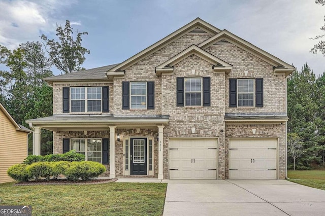 view of front of property featuring a garage and a front lawn