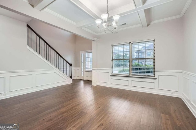 interior space featuring coffered ceiling, crown molding, beam ceiling, an inviting chandelier, and dark hardwood / wood-style floors