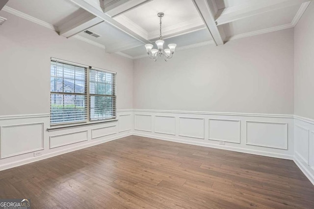 unfurnished room with ornamental molding, coffered ceiling, beam ceiling, hardwood / wood-style flooring, and an inviting chandelier