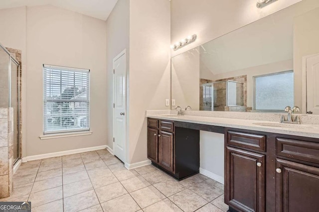 bathroom featuring tile patterned floors, vanity, a shower with shower door, and lofted ceiling