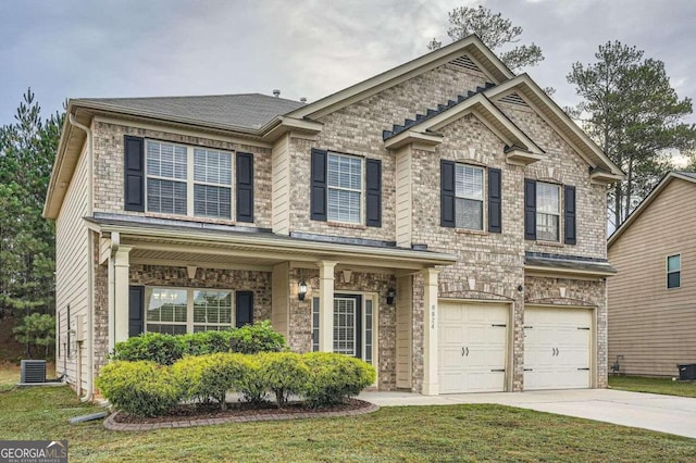 view of front of home with central AC, a front lawn, and a garage