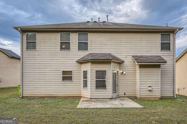 back of property featuring a patio area and a yard