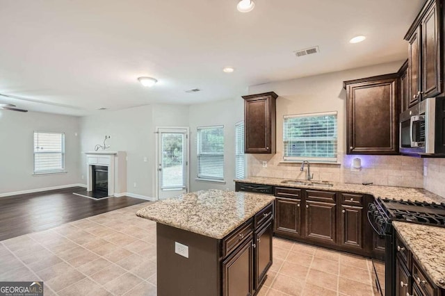 kitchen featuring a kitchen island, a wealth of natural light, and sink