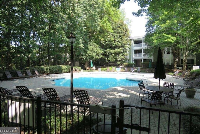 view of swimming pool with a patio