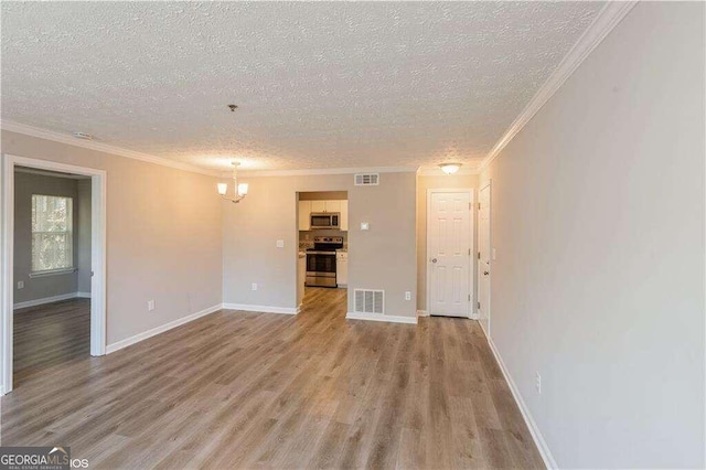 unfurnished living room with ornamental molding, a textured ceiling, and light hardwood / wood-style flooring