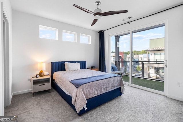 carpeted bedroom with ceiling fan, access to exterior, and multiple windows