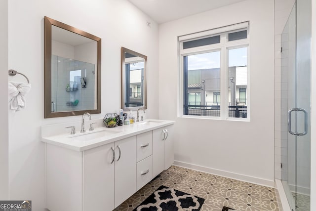 bathroom featuring vanity, plenty of natural light, an enclosed shower, and tile patterned floors