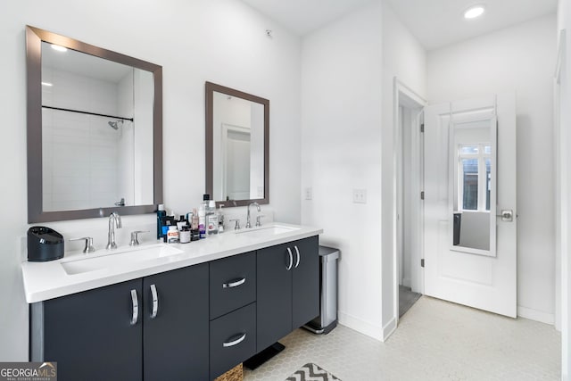 bathroom with vanity and a tile shower