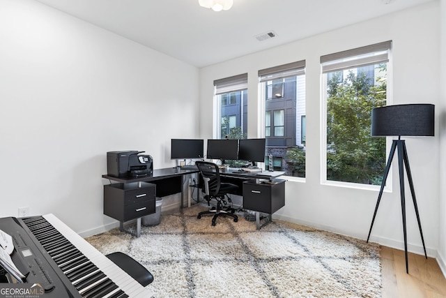 office with light hardwood / wood-style floors