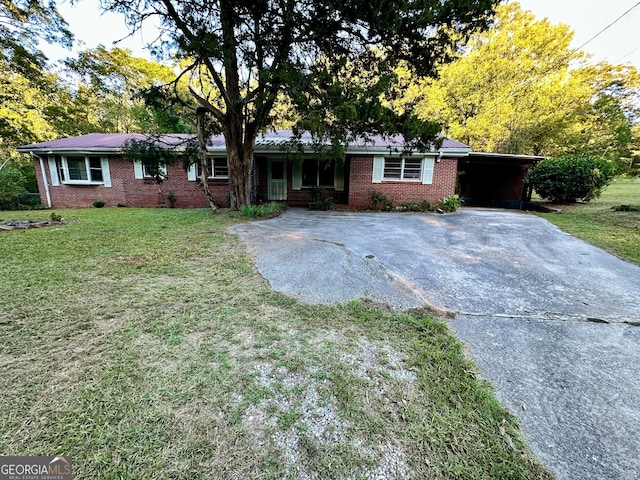 ranch-style home with a front lawn and a carport