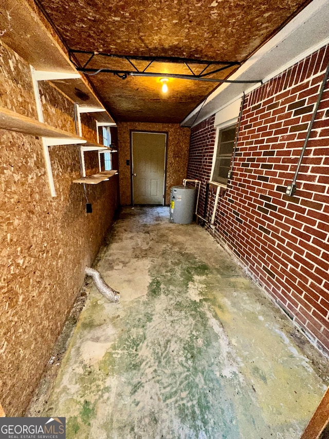 basement featuring brick wall