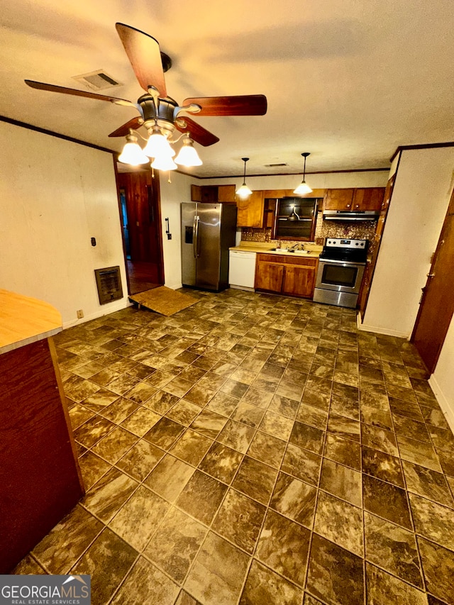 kitchen with ceiling fan, sink, hanging light fixtures, appliances with stainless steel finishes, and backsplash