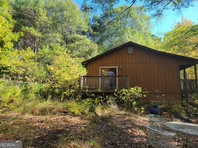 view of side of property with a wooden deck