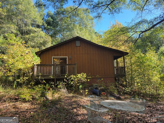 rear view of house with a wooden deck