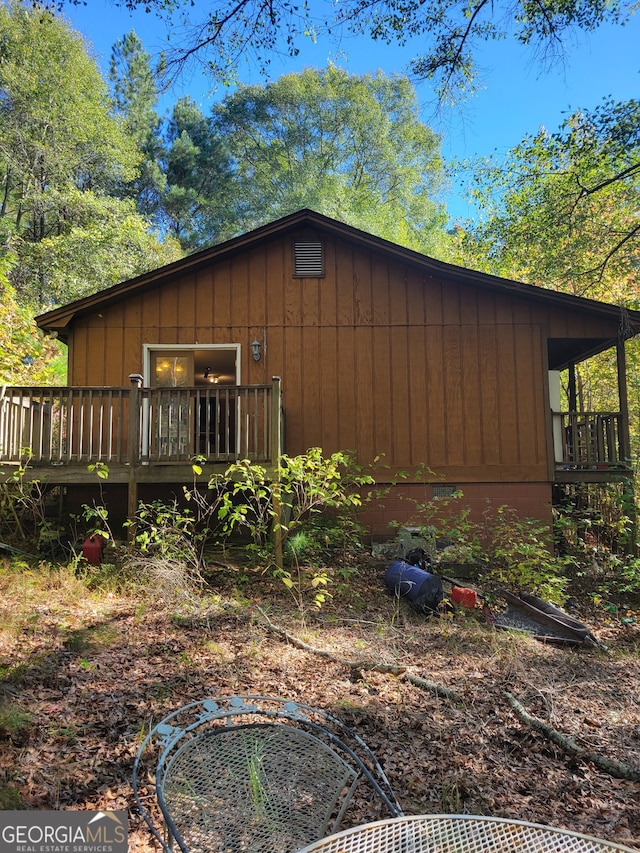 view of property exterior with a wooden deck