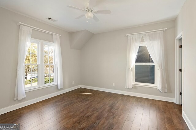 bonus room with ceiling fan, dark wood-type flooring, and a wealth of natural light