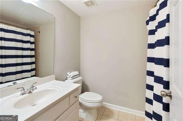 bathroom with tile patterned flooring, vanity, and toilet