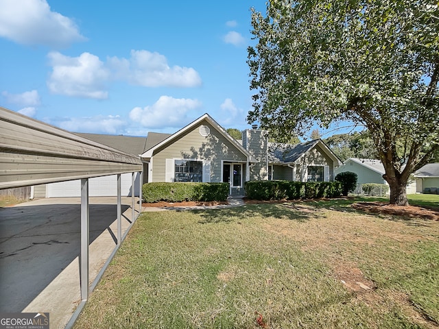 view of front facade featuring a garage, an outbuilding, and a front lawn