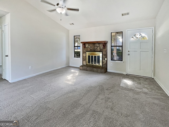 unfurnished living room featuring a fireplace, lofted ceiling, carpet, and ceiling fan