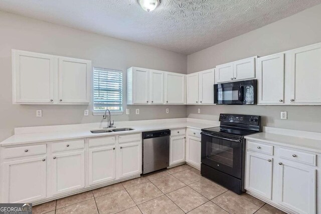 kitchen featuring sink, light tile patterned floors, a textured ceiling, white cabinets, and black appliances