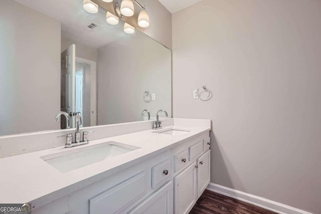 bathroom featuring hardwood / wood-style floors and vanity