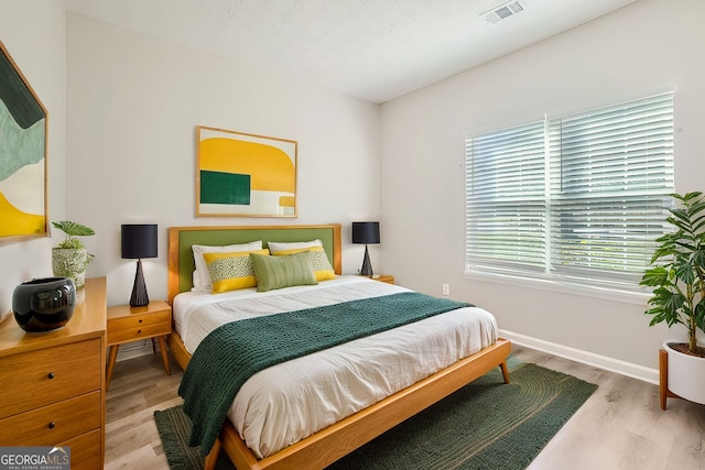 bedroom with light wood-type flooring