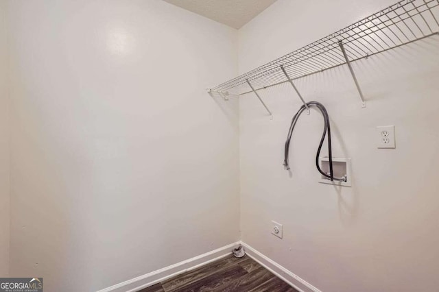 washroom featuring electric dryer hookup, wood-type flooring, and washer hookup