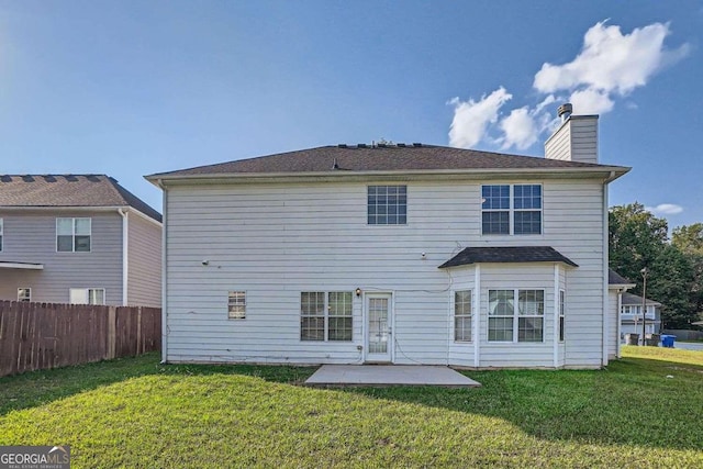 back of property featuring a yard and a patio