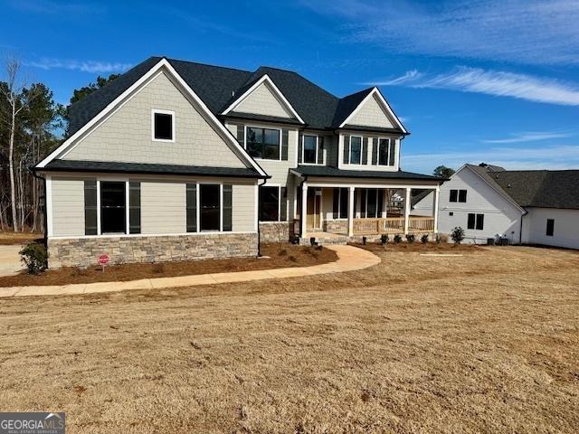 craftsman-style house with covered porch and a front lawn