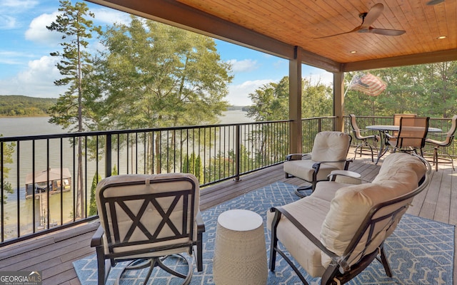 wooden terrace featuring a water view and ceiling fan