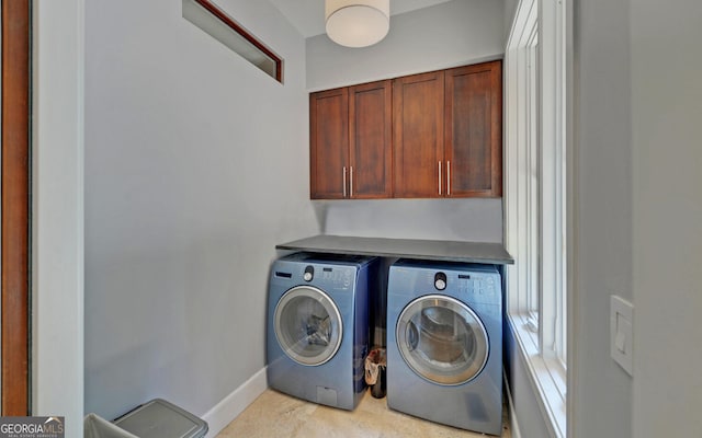 washroom with cabinets and separate washer and dryer