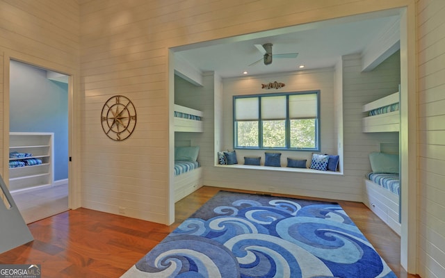 bedroom featuring wood walls and hardwood / wood-style flooring