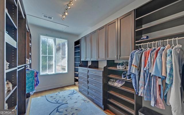 walk in closet featuring light hardwood / wood-style flooring