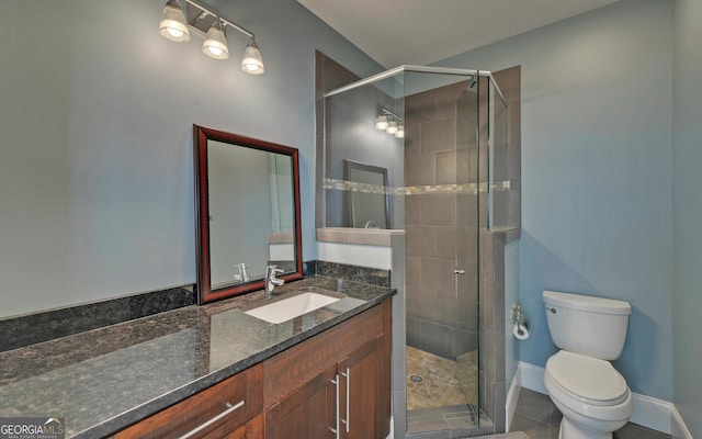 bathroom featuring walk in shower, tile patterned flooring, vanity, and toilet