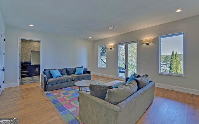 living room featuring light hardwood / wood-style floors and french doors