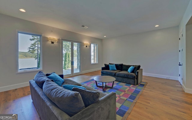 living room with french doors and wood-type flooring