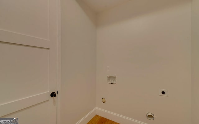 laundry room with light hardwood / wood-style floors, hookup for a washing machine, hookup for a gas dryer, and electric dryer hookup