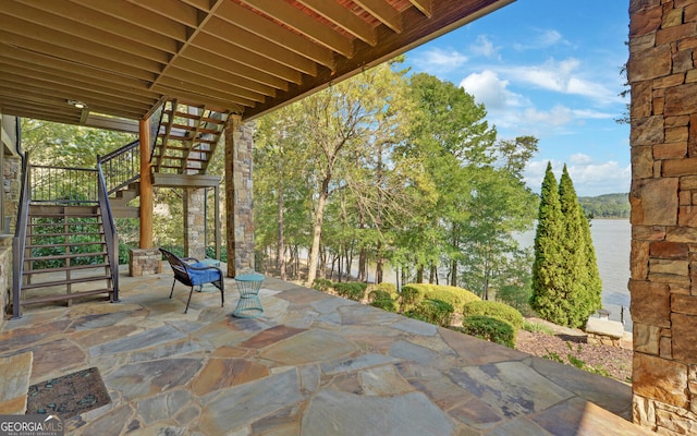 view of patio with a water view