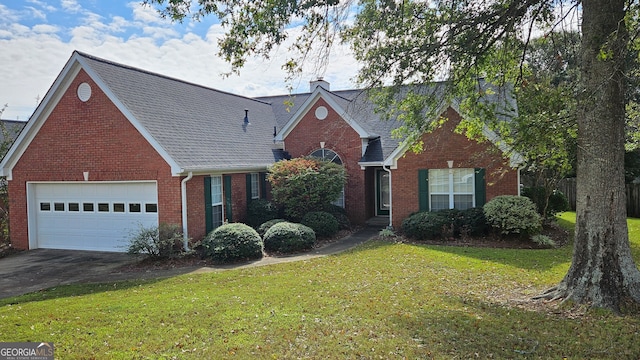 view of front of house with a garage and a front yard