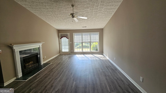 unfurnished living room with dark hardwood / wood-style flooring, a textured ceiling, and ceiling fan